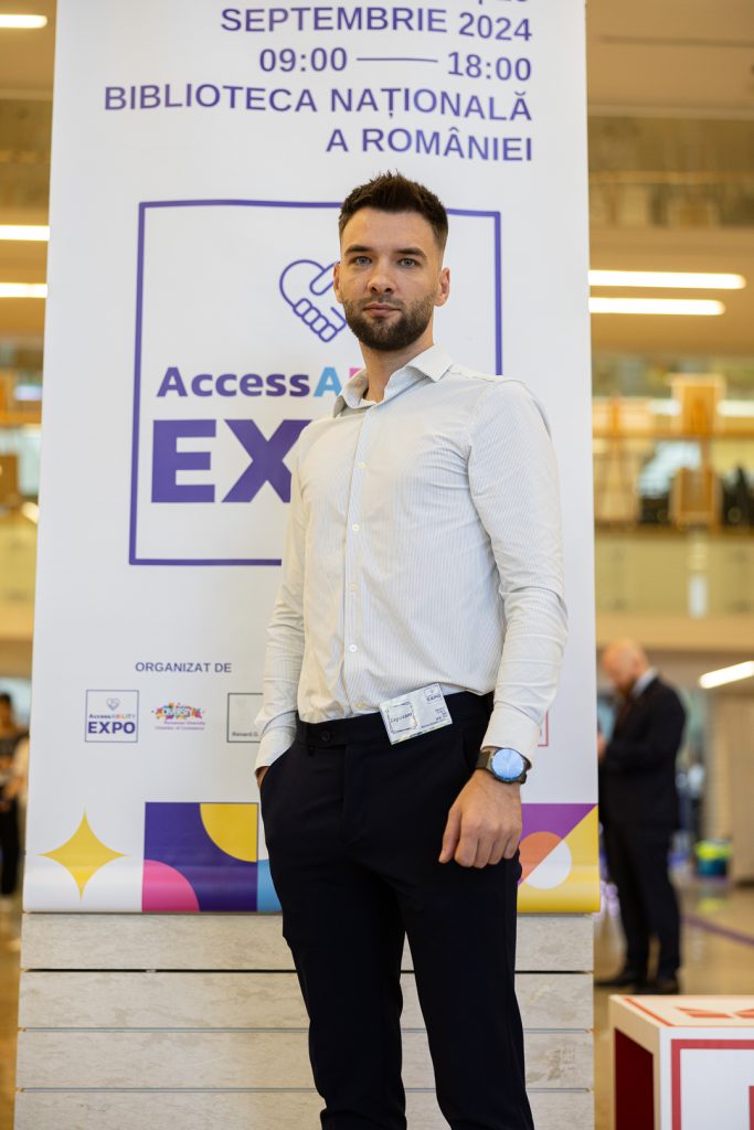 Codrin Podaru standing in front of a banner saying AccessABILITY Expo - only just seen